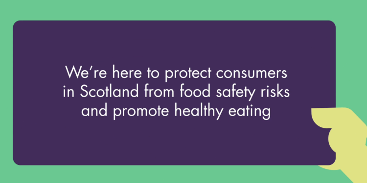 Hand holding a sign that says 'we're here to protect consumers in Scotland from food safety risks and promote healthy eating'